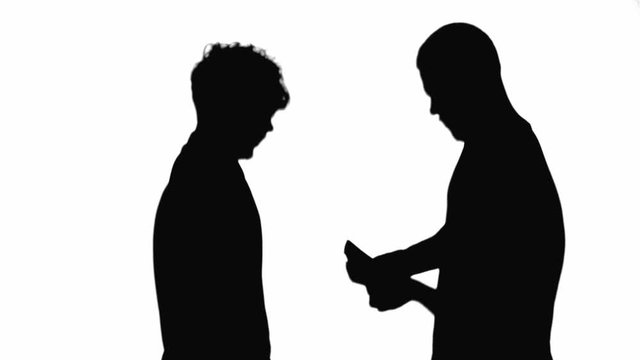 Two silhouettes of concentrated men counting money isolated on white