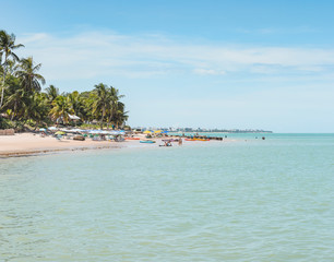Local people and tourists at Praia do Bessa beach, Joao Pessoa PB, Brazil. Beachfront buildings on background.