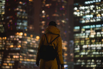 The girl admires the huge buildings