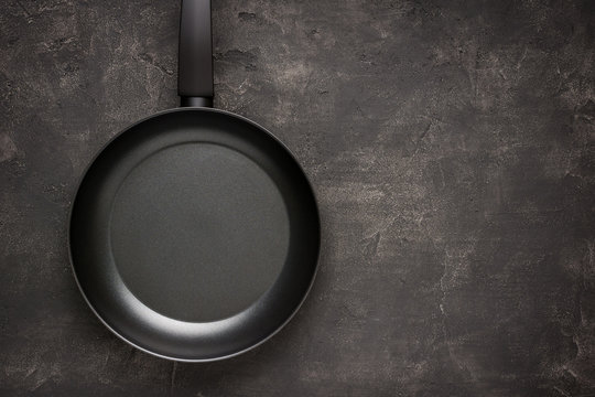 Empty Frying Pan Black on Dark Stone Surface. Culinary Background.