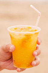 Hand holding a Caipirinha de Seriguela drink. An alcohol drink with Spondias fruit, typical of Brazil. Drink of Brazilian Northeast.