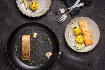 Grilled Salmon Fillet with Saffron Risotto on Dark Background