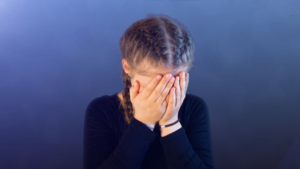 Teenage girl with pigtails, being attacked by social media, creating emotional stress