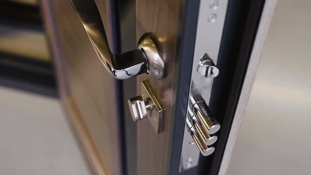 Armored entrance doors with cylinder lock and iron door handle with wooden lining