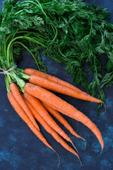 Bunch of carrots on a wooden table with copy space