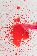 Splashes of blood dripping into the sink in the bathroom.