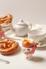 Rustic Breakfast. Boiled eggs and pastries on white wooden background