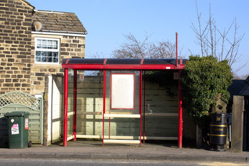A bus stop, complete with inviting, useful noticeboard, ideal for sending a transport message
