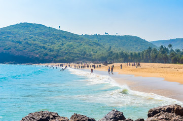Yarada Beach, Visakhapatnam, India 10 December 2018 - People relaxing and enjoying in Yarada Beach. The Coast area is surrounded by hills and Bay of Bengal with lush green trees and golden soft sands.