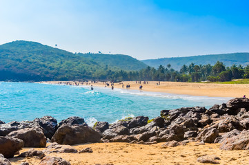 Yarada Beach, Visakhapatnam, India 10 December 2018 - People relaxing and enjoying in Yarada Beach. The Coast area is surrounded by hills and Bay of Bengal with lush green trees and golden soft sands.