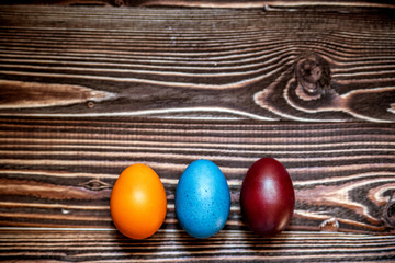 Easter multicolored eggs on a wooden background.