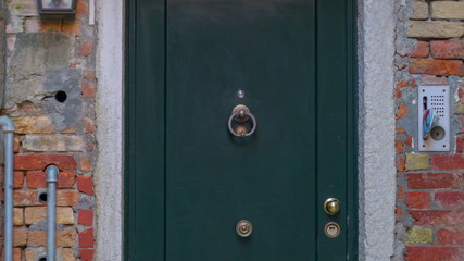 14522_Closer_look_of_the_metal_knocker_of_the_green_door.jpg