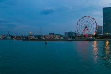 Obraz premium Batumi, Adjara, Georgia. View from the sea on illuminated resort town at evening