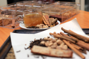 Brewed healthy herbal tea on a wooden background with all dry herbs ingredients. Herbal teas beverage for chinese or thai traditional alternative medicine therapy. 