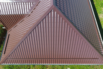 A view from above on the roof of the house. The roof of corrugated sheet. Roofing of metal profile wavy shape