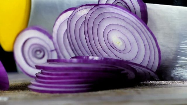Italian red Tropea onions cutted slice before frying in extra virgin olive oil in slow motion , concept of Italian and Mediterranean diet , diet concept and healthy life