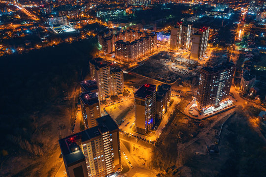 Aerial panoramic view, flight on drone above night city Voronezh with illuminated roads and high-rise buildings © DedMityay