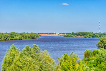 Picturesque summer landscape with view from hill to Volkhov river and ancient Kremlin on horizon. Beautiful scenery with architectural landmark. Velikiy Novgorod, Russia