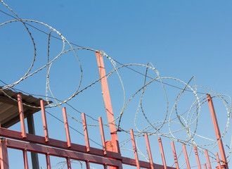 barbed wire on the metal fence around the object