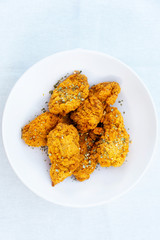 Chicken Wings Spicy chicken wings, breaded, fried, cooked.