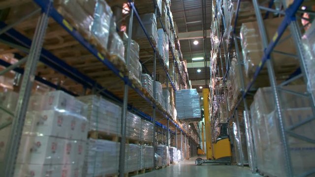 A variety of goods and cargo on the shelves in a large warehouse