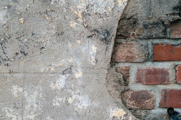 close up of cement patch over weathered red brick wall