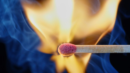 Macro shot of a wooden matchstick igniting in a millisecond of a small but powerful explosion.