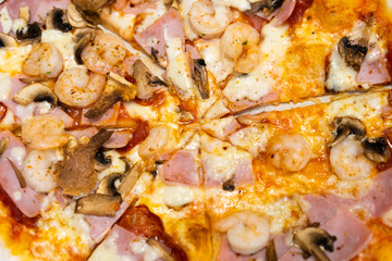 Closed up of seafood pizza on wooden table.