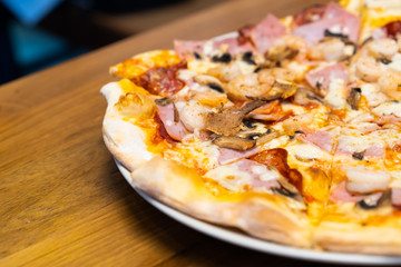 Closed up of seafood pizza on wooden table.