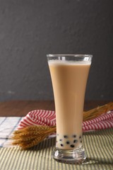 glass of milk and cookies on wooden background