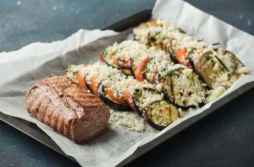 Veal tenderloin with vegetables, eggplants and tomatoes.