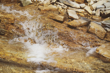 the river flows in the mountains in spring