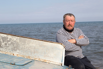 The captain sits on a boat