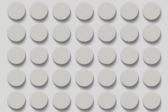 Stack of supplement effervescent tablets pattern texture. Multivitamin supplement tablet. Soluble Vitamin. Fizzy tablets isolated on soft gray background. © sabir