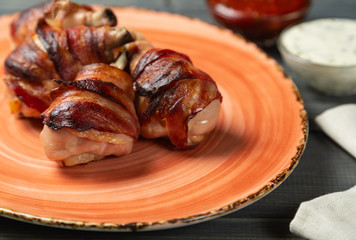 Fried chicken legs wrapped in bacon. The view from the top. Copy-space.