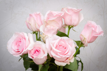 A beautiful bouquet of fresh pink roses in an expensive vase