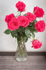 A beautiful bouquet of fresh pink roses in an expensive vase