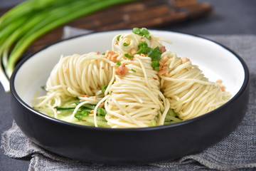 pasta with pesto sauce and basil