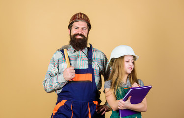 daughter and father repairing together in workshop. Fatherhood. Bearded man with little girl. engineering education. construction worker assistant. Industry. Tools for repair. He is ready to work