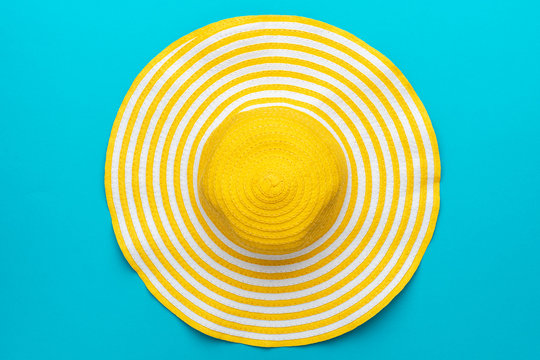 top view of yellow hat on blue background