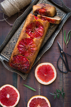 Grapefruit cake on wooden tanle aerial view