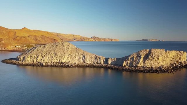 Aerial sidewards dolly, flying along Gongaza bay in Baja, Mexico during golden hour.