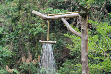 Outdoor refreshing shower head made from steel pipe in the park.