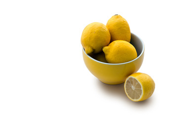 Yellow bowl full with lemons with copy space