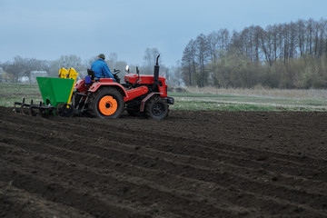 Fototapeta premium the tractor is developing the ground