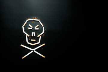 Skull from cigarettes on a black background. The concept of smoking kills. Toward the concept of smoking as a deadly habit, nicotine poisons, cancer from smoking, illness, quit smoking.