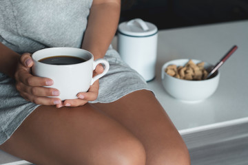 young woman drinking coffee at home