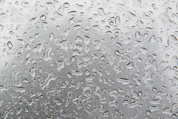 water drops on grey metal surface