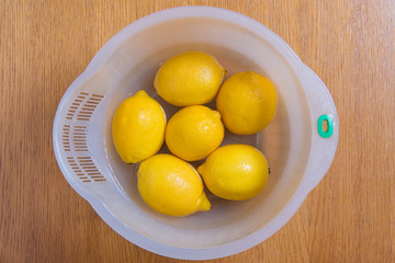 Fresh yellow lemons on a wooden background.