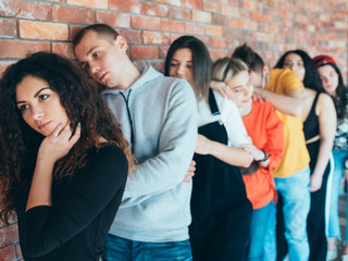 Millennials beginning professional career. Young candidates standing in queue, waiting for interview. Competitive job market.